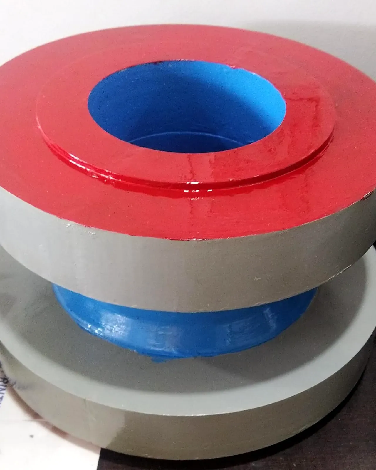 Painted 3D-printed flange casting pattern in red, grey and blue